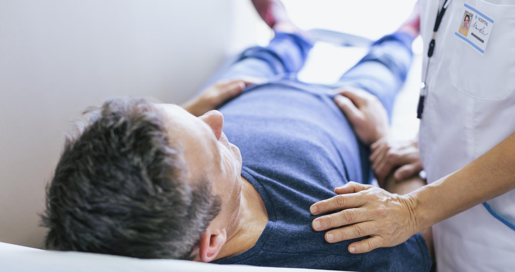 Paciente en camilla revisado por un médico